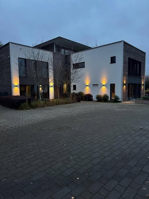 Exterior wall lighting on a modern home at dusk